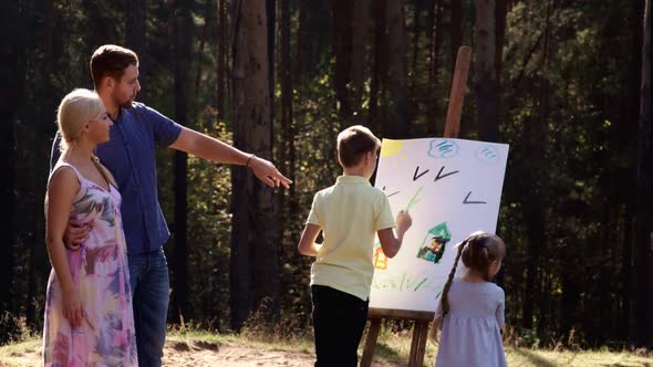 Happy Family Young Parents Drawing Coloring Picture with Brush Helping Cute Child Daughter Enjoying