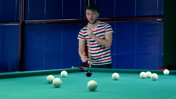 Young Man Lubricates Cue Chalk Before Impact