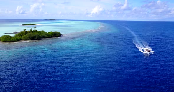 Natural fly over tourism shot of a white sandy paradise beach and turquoise sea background