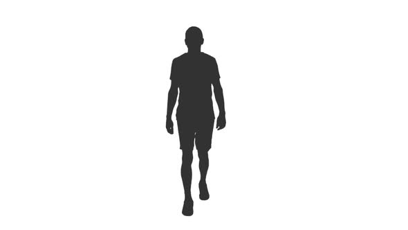 Silhouette of Young Man Walks in T-shirt and Shorts