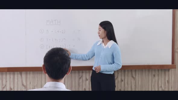 Teacher is teaching in the classroom