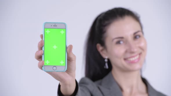 Face of Happy Young Beautiful Businesswoman Showing Phone