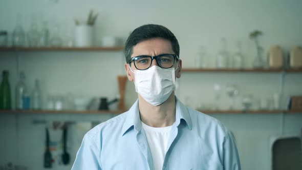 Coronavirus, Covid-19 Concept. A Man in Glasses Is Taking Off a Medical Mask and Smiling