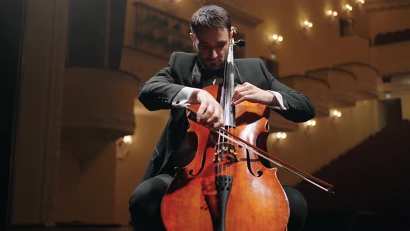 Inspired Cellist is Playing Violoncello on Scene in Old Opera House Rehearsal or Concert of