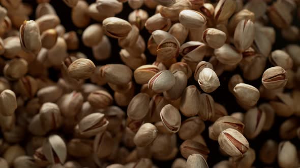 Super Slow Motion Shot of Pistachios Flies After Being Exploded Against Black Background, 1000Fps.