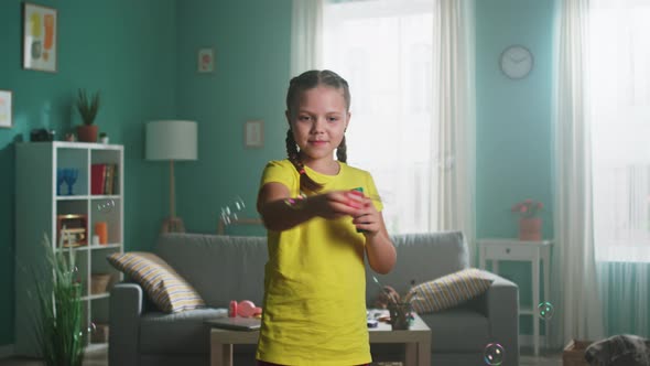 Small Girl Is Playing with Bubbles