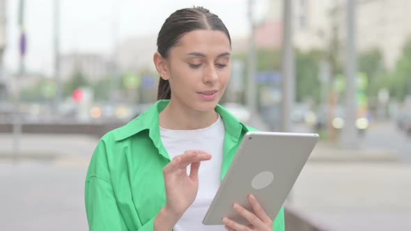 Hispanic Woman Using Digital Tablet Outdoor