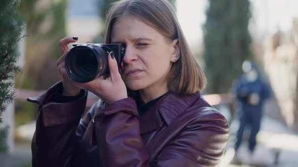 Portrait of Smart Curios Female Investigator Taking Photo with Camera at Crime Scene