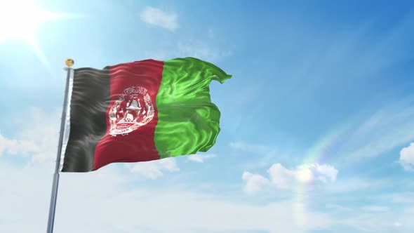 Flag Of Afghanistan Flying Against A Blue Sky