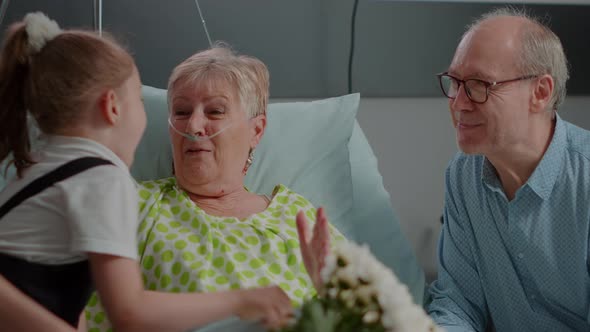 Close Up of Ill Pensioner Receiving Visit From Daughter and Niece