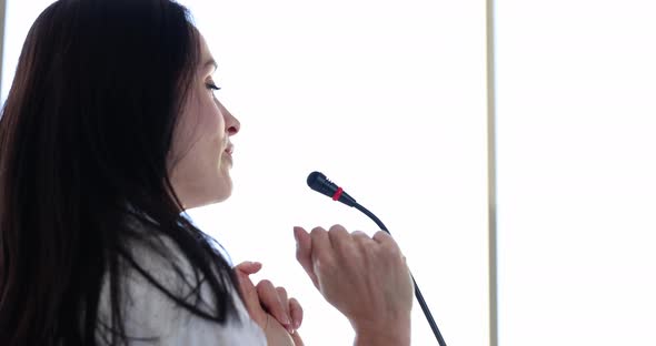 Young Woman Speaker Speaking Into Microphone at Presentation  Movie Slow Motion