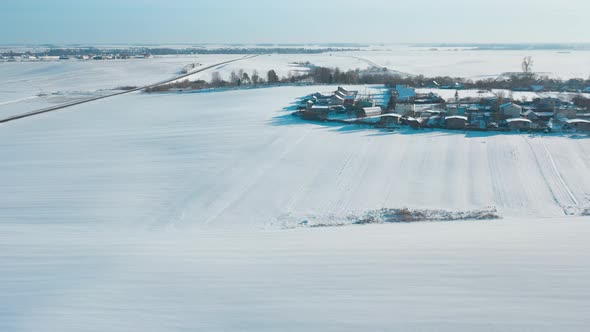 Countryside Road And Village Snowcovered Gardens And Field In Winter Day