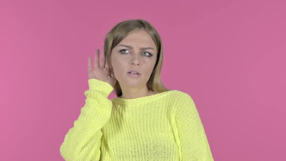 Surprised Young Girl Trying to Listen Secret Pink Background