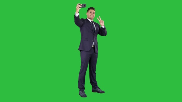 Business man taking selfie on a Green Screen, Chroma Key.