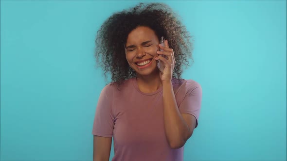 Young Emotional African American Woman Talks on Phone, Rejoices Good News