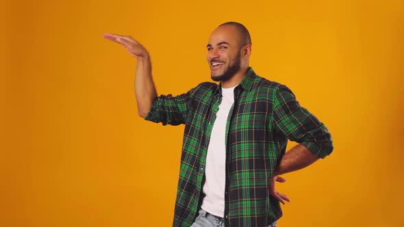 Happy Young African American Man Doing Funny Egyptian Dance Against Yellow Background