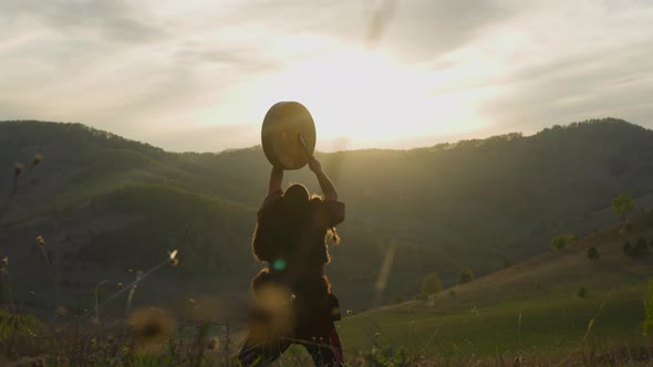 Altai Man Plays Shaman Drum Praying Among Green Highland