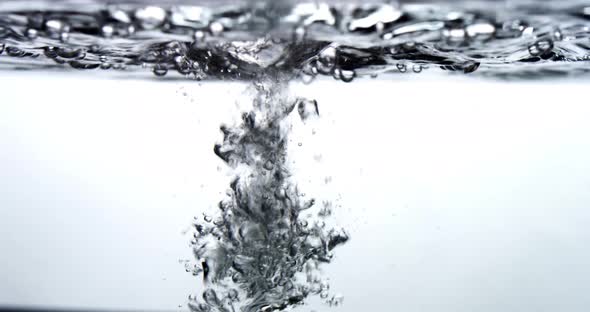 Water drips into a water surface - white background