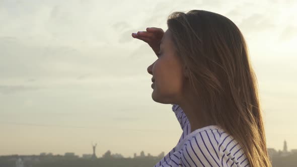 Cute Girl Looking Into the Distance of the City