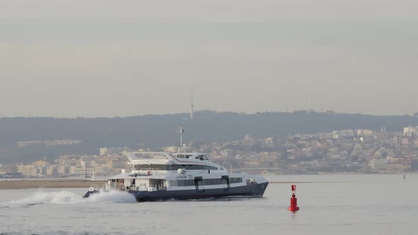 Passenger Boat Transport In Tagus River With Lisbon City In The Background - wide shot