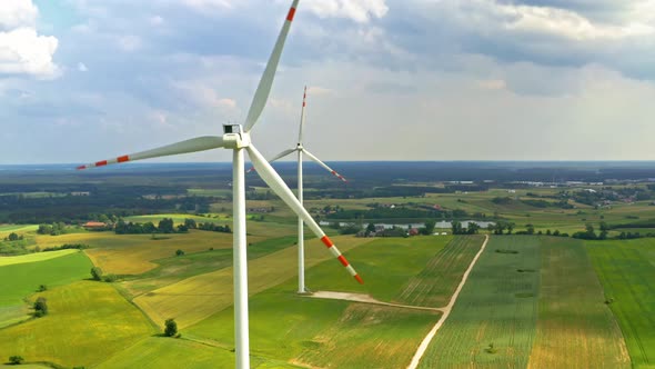 White wind turbines on field, aerial view in Poland