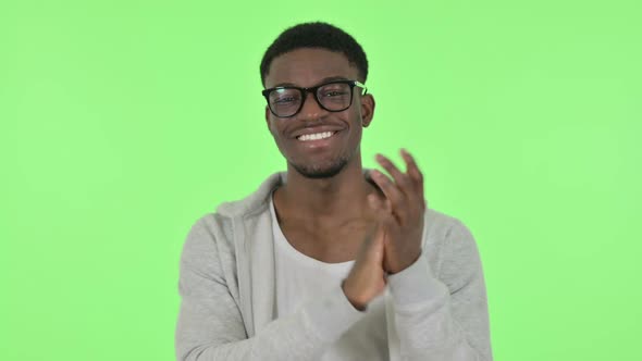 African Man Clapping Applauding on Green Background