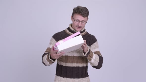 Happy Bearded Man Looking Surprised and Opening Gift Box