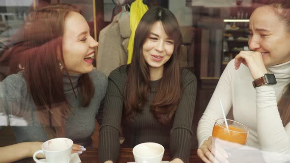Women Girlfriends in a Cafe.