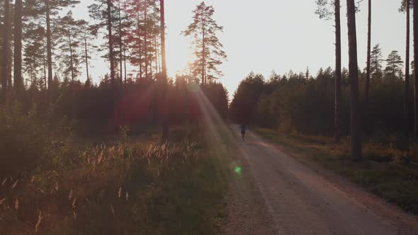 Man running along forest path