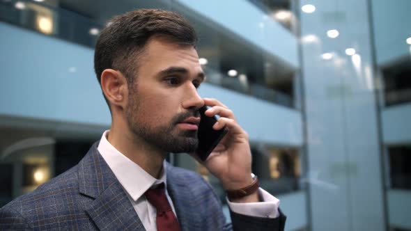 Businessman Talking on Cellphone in Hotel Lift