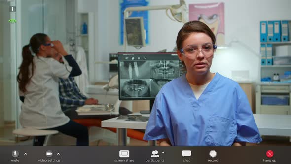 Dental Assistant Explaining To Patients the Importance of Oral Hygiene