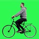 Happy Man Riding a Bicycle Over a Green Screen, Looking Around - VideoHive Item for Sale