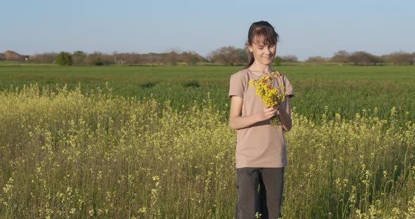 Teen in Flowers Field in Summer