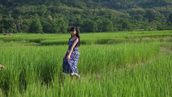 Little Girl Spinning Around In Rice Field