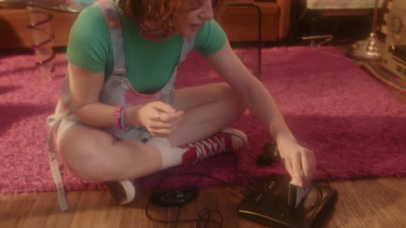 Girl Putting Game Cartridge in Console