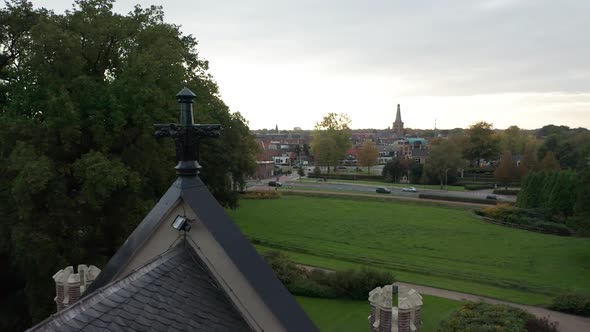 High angle view from artwork on roof of old mansion overlooking green garden