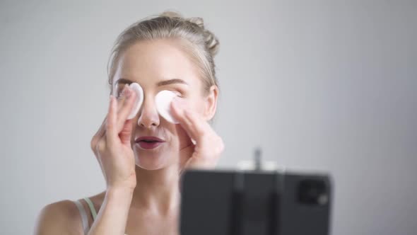 Portrait of Female Beauty Blogger Woman Shows How to Face Massage with Cotton Pads Makes a Stream