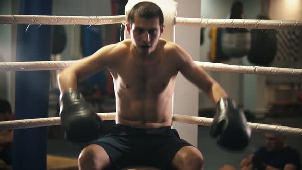 Man with a Teeth Guard Sit  on the Ring and Smiling