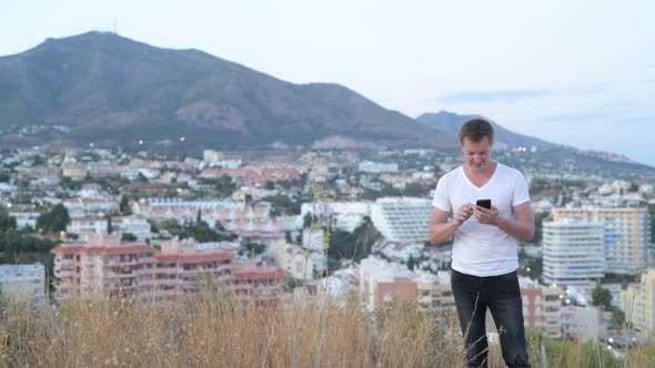 Young Handsome Tourist Man Smiling While Taking Selfie On The Hill