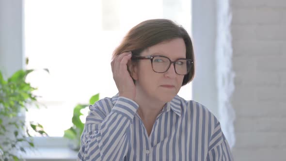 Portrait of Senior Woman Listening Secret Carefully Information