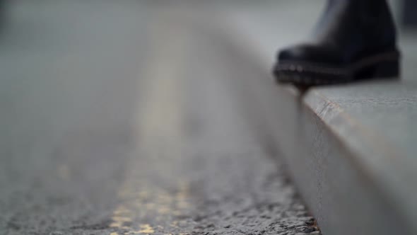 Feet of Young Woman on Asphalt in City at Cloudy Autumn Day, Black Leather Shoes, Closeup View