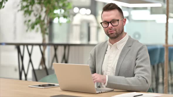 Creative Man with Laptop Saying No with Finger Sign