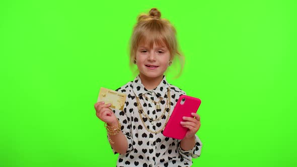 Little Teen Kid Child Girl Using Credit Bank Card and Smartphone While Purchases Online Shopping