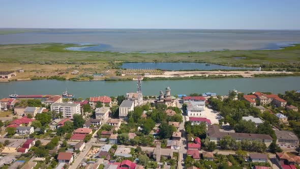 Aerial View Of Sulina City Harbor And The Danube Flowing Into The Black Sea