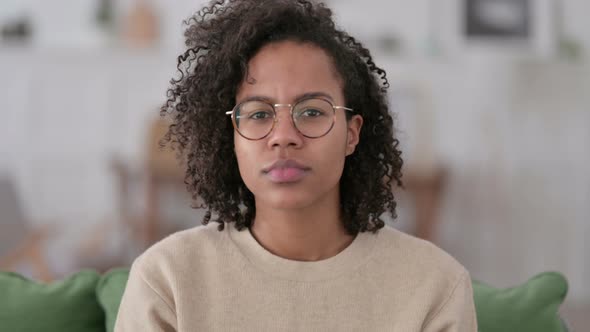 Portrait of Young African Woman Pointing at Camera