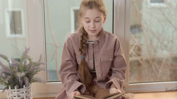 Girl with a Book Near the Window