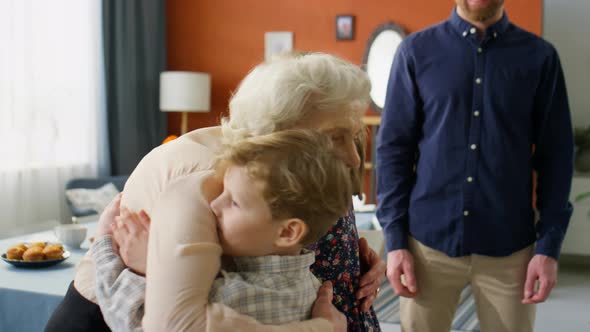 Joyous Grandma Greeting Little Grandkids at Home