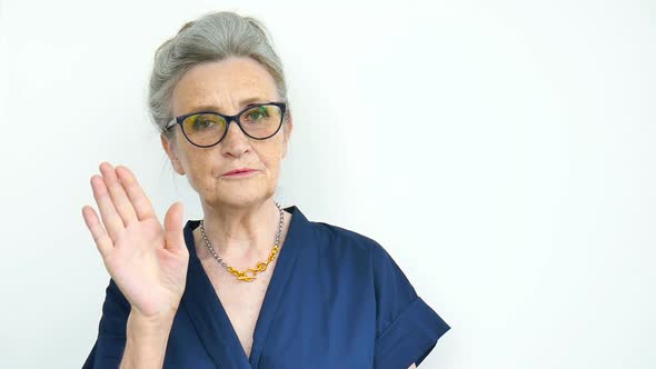 Female Portrait of Serious Grandmother with Grey Hair and Face with Wrinkles Wearing Eyeglasses on