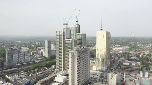 Drone Aerial shot of Woking Cityscape a town in England with high rise skyscrapers and cranes buildi