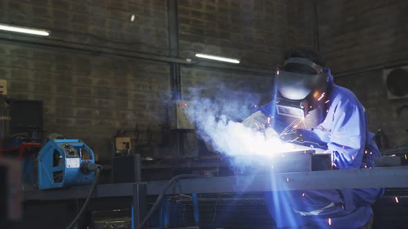 asian male technician worker in a safty uniform wear welders leathers